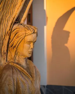 a statue of a woman holding an umbrella at Vila Silva Marija Apartments in Pišece