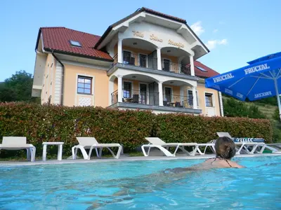 a person in the swimming pool at a hotel at Vila Silva Marija Apartments in Pišece