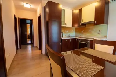a kitchen with a table and a dining room at Vila Silva Marija Apartments in Pišece