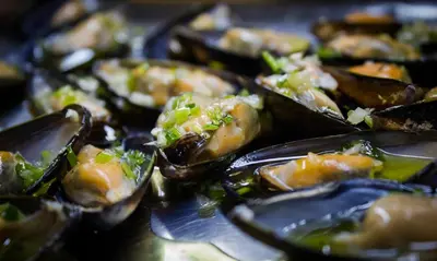 a plate of food with oysters on a table at Hotel Krona Domžale in Domžale