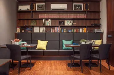 a dining room with two tables and a couch at Hotel Mrak in Ljubljana
