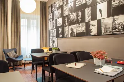 a restaurant with tables and chairs and pictures on the wall at Hotel Mrak in Ljubljana