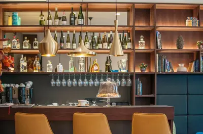 a bar with chairs and bottles on the shelves at Hotel Mrak in Ljubljana