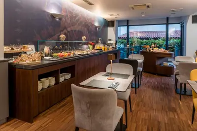 a restaurant with a buffet with tables and chairs at Hotel Mrak in Ljubljana