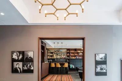 a living room with a chandelier above a doorway at Hotel Mrak in Ljubljana