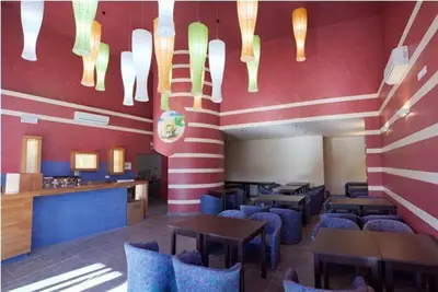 a dining room with tables and chairs in a restaurant at Garni Hotel Siesta in Nova Gorica