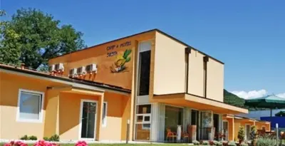 an orange and white building with a balcony at Garni Hotel Siesta in Nova Gorica