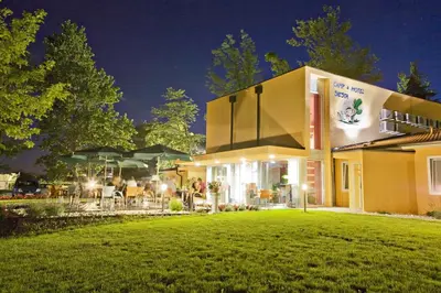 a building with a lawn in front of it at Garni Hotel Siesta in Nova Gorica