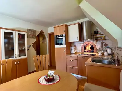 a kitchen with a table with a cake on it at Apartment Crystal Rose in Kranjska Gora