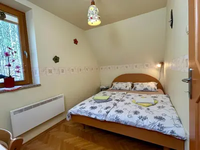 a bedroom with a bed and a window at Apartment Crystal Rose in Kranjska Gora