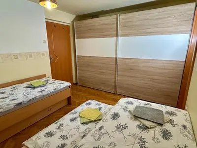 a bedroom with two beds and a sliding glass door at Apartment Crystal Rose in Kranjska Gora