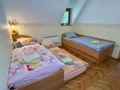 two beds in a small room with two twin beds at Apartment Crystal Rose in Kranjska Gora