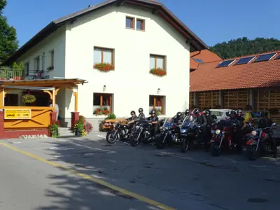 a group of motorcycles parked in front of a building at Guesthouse Mesec Zaplana in Vrhnika