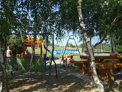 a park with a playground and a swing at Guesthouse Mesec Zaplana in Vrhnika