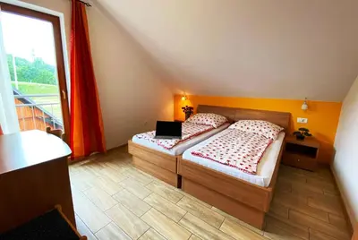 a bedroom with two beds with a laptop on it at Guesthouse Mesec Zaplana in Vrhnika