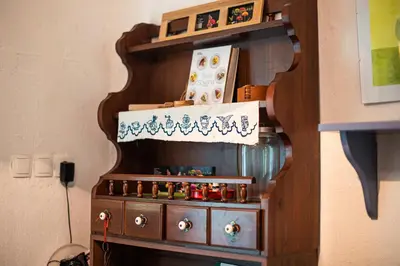 a wooden shelf with a bunch of bottles on it at Vintage House Podliparska in Fara