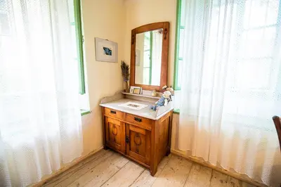 a bathroom with a sink and a mirror at Vintage House Podliparska in Fara