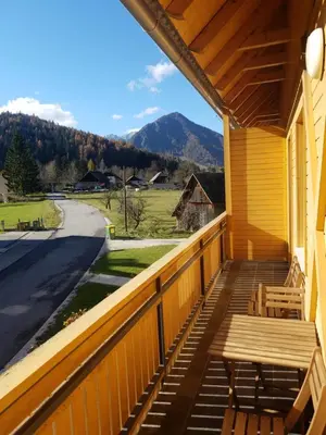 a porch with a bench and a view of the mountains at Sun and Spa Apartment in Kranjska Gora