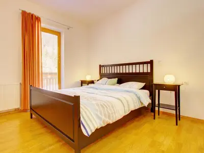 a bedroom with a large bed and a window at Sun and Spa Apartment in Kranjska Gora