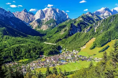 a small town in a valley in the mountains at Sun and Spa Apartment in Kranjska Gora
