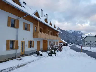a building with snow in front of it at Sun and Spa Apartment in Kranjska Gora
