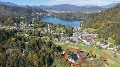 an aerial view of a small town with a red house at Tourist house Capricorn in Bled