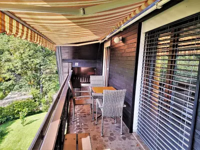 a balcony with a table and chairs on it at Tourist house Capricorn in Bled
