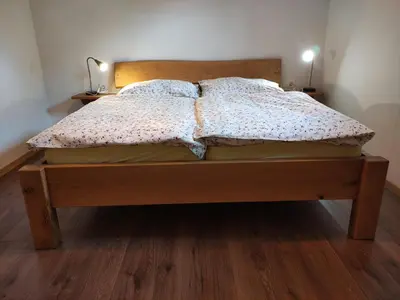a bed with two pillows on it in a bedroom at Green Garden Apartment in Bled