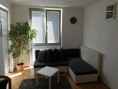 a living room with a couch and a table at Victoria Apartment in Ljubljana