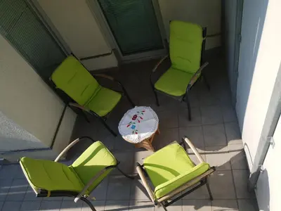 an overhead view of two green chairs and a table at Victoria Apartment in Ljubljana
