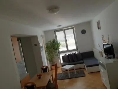 a living room with a couch and a table at Victoria Apartment in Ljubljana