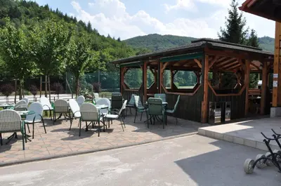 a patio with chairs and tables and a gazebo at Natura Amon in Podčetrtek