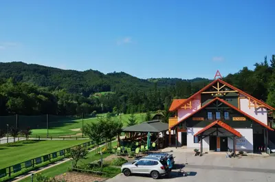 a building with a car parked in front of it at Natura Amon in Podčetrtek
