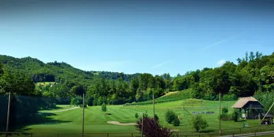 a green golf course with a gazebo at Natura Amon in Podčetrtek