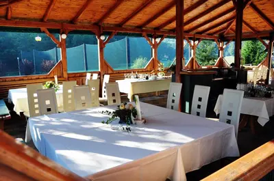a dining room with a white table and chairs at Natura Amon in Podčetrtek