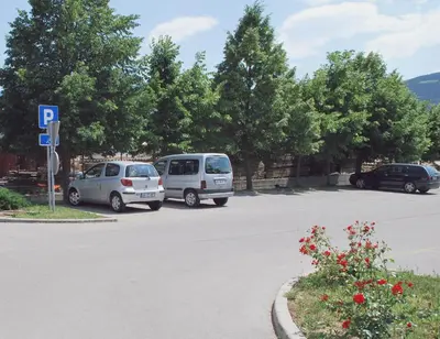 two cars are parked in a parking lot at Bed and Breakfast Kogoj in Nova Gorica