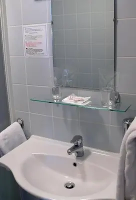 a bathroom with a sink and a glass shelf at Bed and Breakfast Kogoj in Nova Gorica