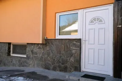 a white door on the side of a building at Apartment Jorsi with Mountain View in Zreče