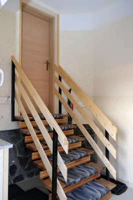 a staircase in a house with a wooden door at Apartment Jorsi with Mountain View in Zreče