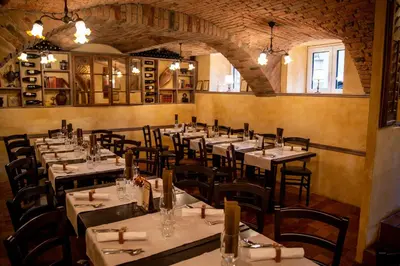 a restaurant with tables and chairs in a room at Apartments Hiša Pod Gradom in Ljubljana