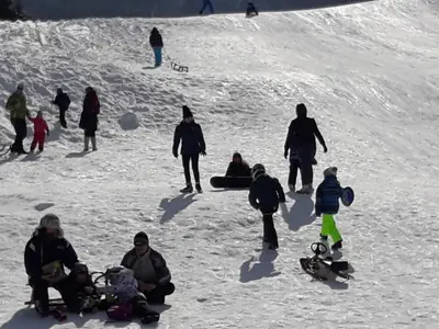 a group of people on a snow covered slope at Snežak (Snowman) in Bohinj