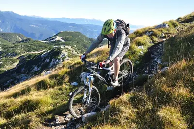 a man riding a bike on a hill at Snežak (Snowman) in Bohinj