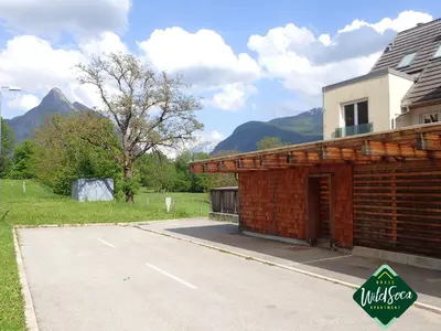 a brick building on the side of a road at Wild Soca House Apartment No.5 in Bovec