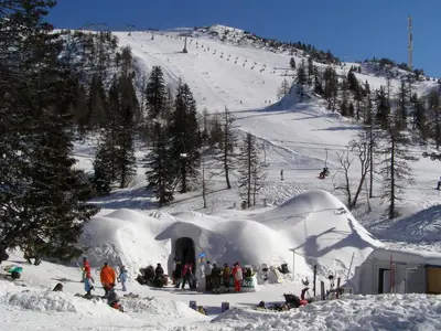 a group of people in an igloo in the snow at Pr'Simi in Golnik