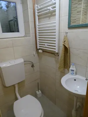 a bathroom with a toilet and a sink at Sobe- Rooms - Apartments - Free parking! in Maribor