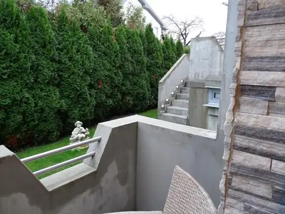 a stairway with a statue on the side of a building at Sobe- Rooms - Apartments - Free parking! in Maribor