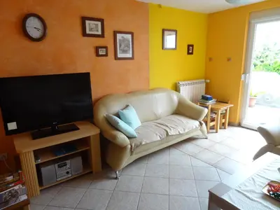 a living room with a couch and a flat screen tv at Sobe- Rooms - Apartments - Free parking! in Maribor