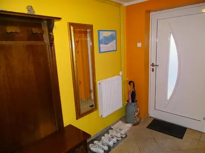 a bathroom with a sink and a mirror and a door at Sobe- Rooms - Apartments - Free parking! in Maribor