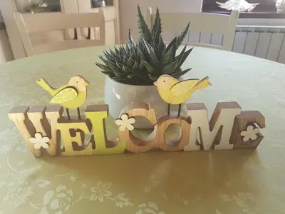 a wooden sign with two birds on a table at Apartment Slavi in Vipava