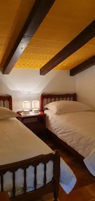 a bedroom with two beds and two lamps on tables at Apartment Slavi in Vipava